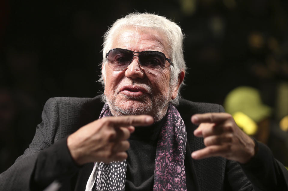 Italian fashion designer Roberto Cavalli gestures as he talks with journalists prior to the start of the Roberto Cavalli men's Fall-Winter 2014 show, part of the Milan Fashion Week, unveiled in Milan, Italy, Tuesday, Jan.14, 2014. (AP Photo/Luca Bruno)