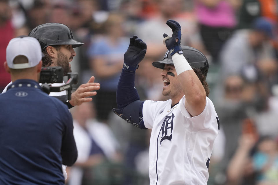 Detroit Tigers' Zach McKinstry, right, is greeted at home plate by Jake Marisnick after they both scored on McKinstry's two-run home run during the fourth inning of a baseball game against the Arizona Diamondbacks, Sunday, June 11, 2023, in Detroit. (AP Photo/Carlos Osorio)