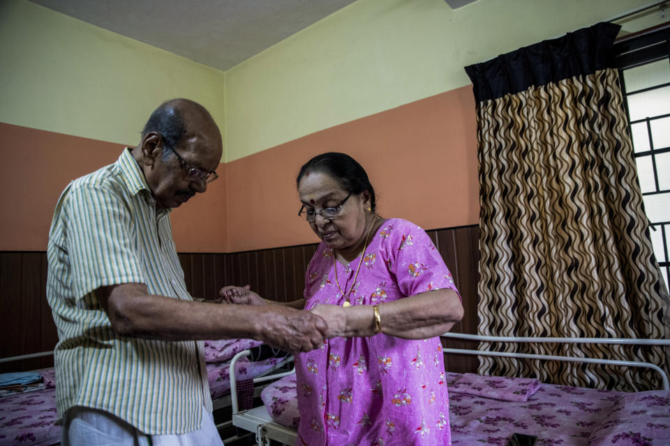 V.Baby, an 84-years-old retired math professor assists his wife Vasanthi, 82 years, walk inside their room at the Signature Aged Care in Kochi, Kerala state, India, March 30, 2023. The couple tried living in their home for a few years but with age-related health conditions catching up and unable to maintain the enormous home, they took a call to move to the assisted living center which is just a few kilometers from their home. Here, Baby is happy with the care he and his wife receive. "There is a feeling of safety we can only get here. We cannot get this at home," he said. (AP Photo/ R S Iyer)