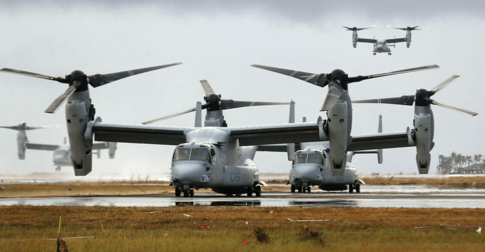 Four Ospreys from the U.S. Navy Seal ship Charles Drew arrive or taxi on the tarmac of the Tacloban airport