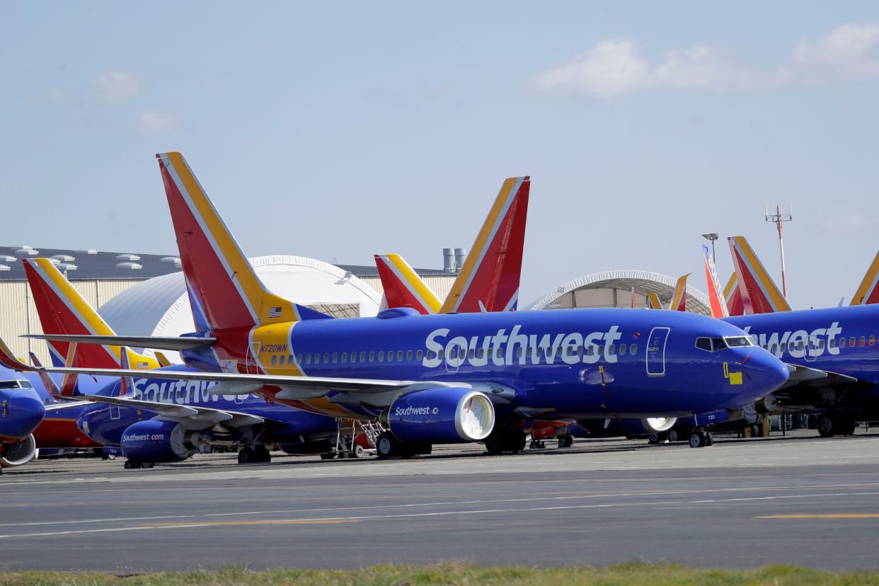 In this Tuesday, April 7, 2020, file photo, Southwest Airlines airplanes sit parked at Paine Field airport in Everett, Wash.