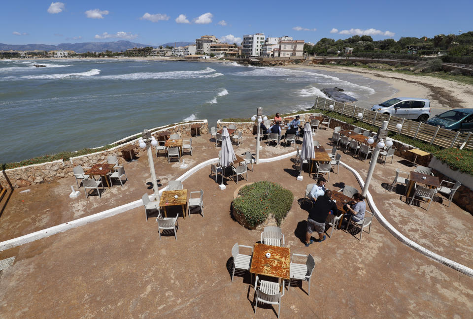 11 May 2020, Spain, Palma: People sit on the terrace of the bar El Pe-on by the sea. From Monday, in "Phase 1" of the relaxation of the corona measures, bars, restaurants, shops, libraries and religious places of worship, among others, will be allowed to reopen. Photo: Clara Margais/dpa (Photo by Clara Margais/picture alliance via Getty Images)