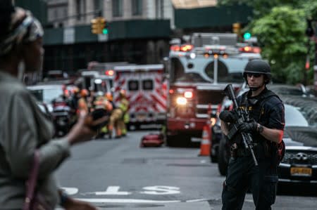 New York City Police Department officer stands guard near the Fulton Street subway station as police said they were investigating two suspicious packages in Manhattan, New York