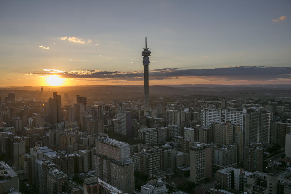 This Friday, April 6, 2018 aerial photo shows Johannesburg's downtown. Millions of migrants jostle for work in the thriving underground economy of Gauteng province, whose name roughly translates to "land of gold." Thousands of them die without identities or simply disappear during the journey. (AP Photo/Bram Janssen)