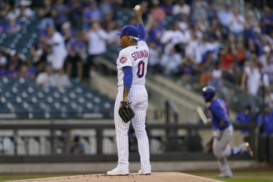 New York Mets starting pitcher Marcus Stroman stretches his arm after allowing a two-run home run to Chicago Cubs' Javier Baez, right, during the first inning of a baseball game Thursday, June 17, 2021, in New York. (AP Photo/Kathy Willens)