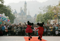 Mickey Mouse and Minnie Mouse characters greet visitors with their latest Year of the Mouse costumes at Hong Kong Disneyland, China in January 21, 2008. REUTERS/Bobby Yip/File Photo