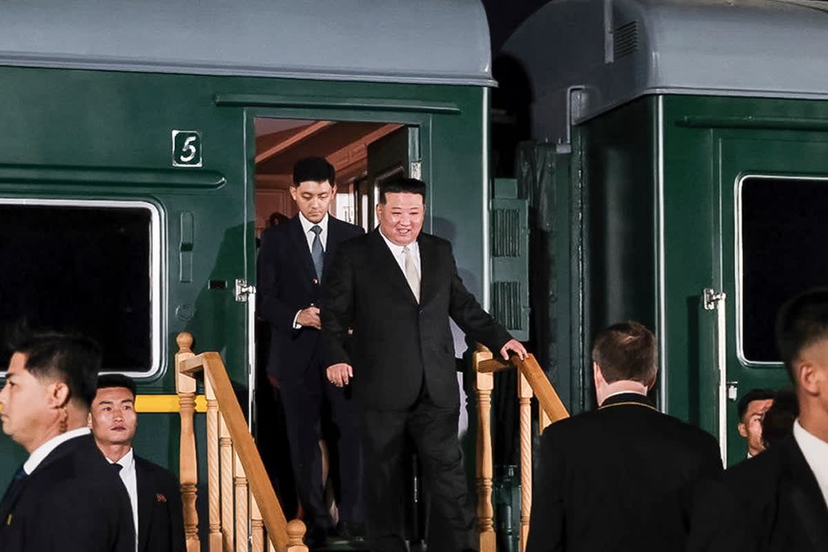 North Korea’s leader Kim Jong-un, center, steps down from his train after crossing the border to Russia at Khasan (AP)