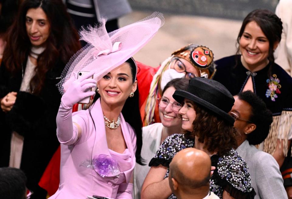 American singer-songwriter Katy Perry takes selfie photos with guests at Westminster Abbey in central London on May 6, 2023, during the coronations of King Charles III and Camilla, Queen Consort. (POOL/AFP via Getty Images)
