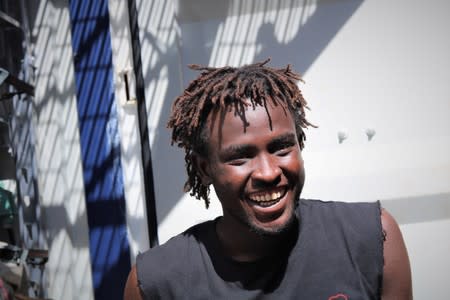 Bob, from Sudan, smiles on the deck of the migrant rescue ship Ocean Viking