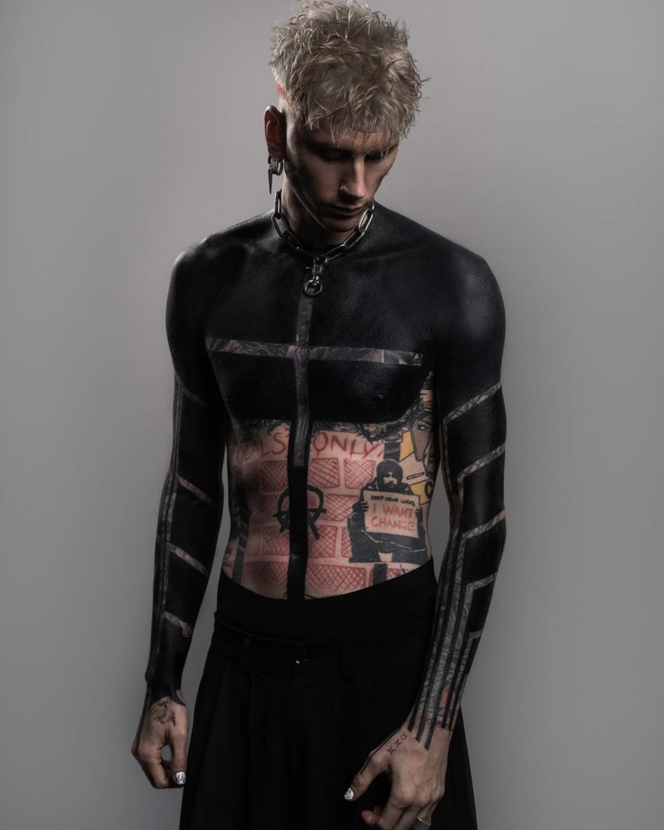 Machine Gun Kelly Covers All of His Arm and Torso Tattoos In Massive