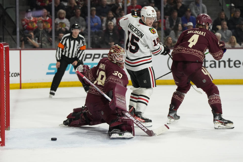 Arizona Coyotes goaltender Connor Ingram (39) can not make the save in front of defenseman Juuso Valimaki (4) and Chicago Blackhawks right wing Joey Anderson on goal scored by center Jason Dickinson in the second period during an NHL hockey game, Tuesday, March 5, 2024, in Tempe, Ariz. (AP Photo/Rick Scuteri)