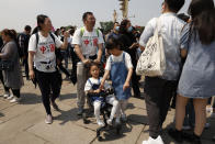 Residents wearing t-shirts which reads "Made In China" visit Tiananmen Gate with two children in Beijing on May 3, 2021. China’s population growth is falling closer to zero as fewer couples have children, the government announced Tuesday, May 11, 2021, adding to strains on an aging society with a shrinking workforce. (AP Photo/Ng Han Guan)