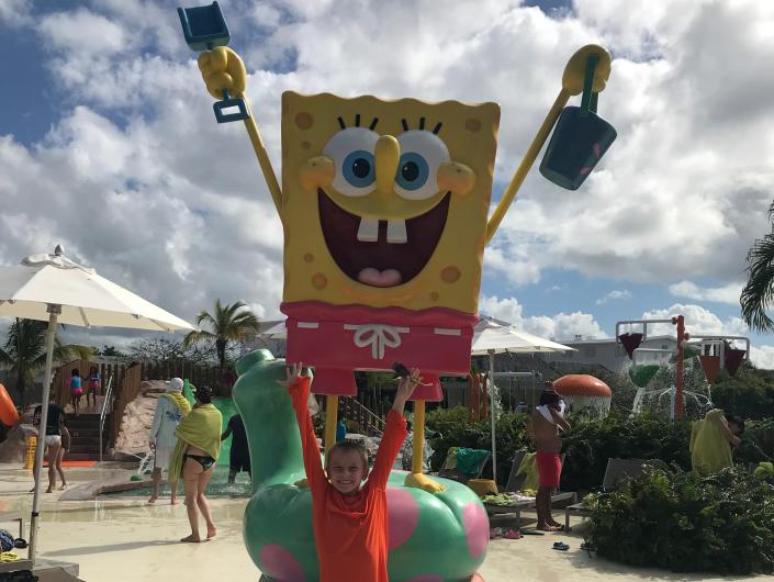 A boy at the AquaNick waterpark with a statue of SpongeBob