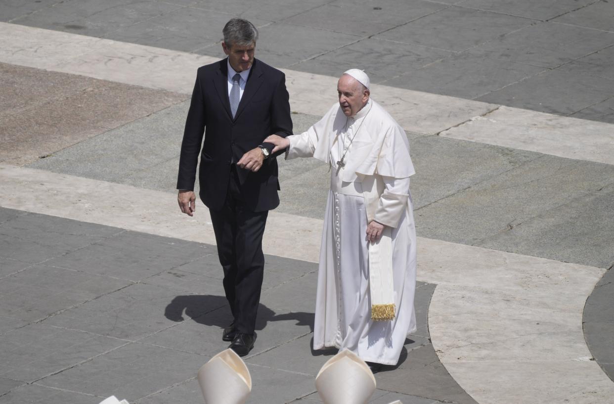 Pope Francis is helped walking at the end of the canonization mass for ten new saints in St. Peter's Square at The Vatican, Sunday, May 15, 2022. 