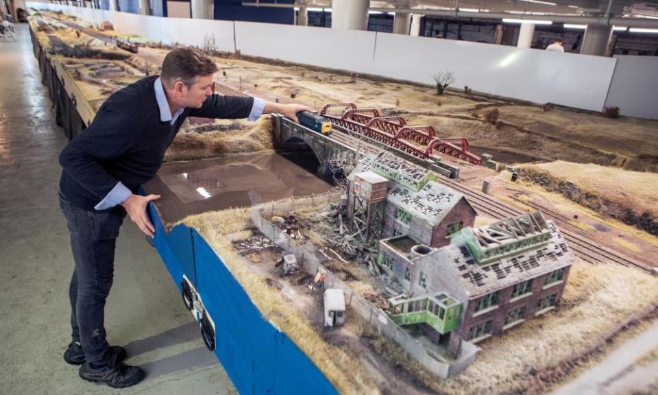 Simon George with his model railway layout, which cost about £250,000 to build.