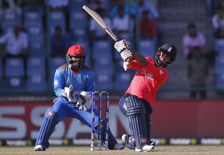 Cricket - England v Afghanistan - World Twenty20 cricket tournament - New Delhi, India, 23/03/2016. England's Moeen Ali (R) plays a shot watched by Afghanistan's wicketkeeper Mohammad Shahzad. REUTERS/Adnan Abidi