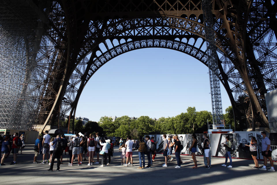 People queue up prior to visit the Eiffel Tower, in Paris, Thursday, June 25, 2020. The Eiffel Tower reopens after the coronavirus pandemic led to the iconic Paris landmark's longest closure since World War II. (AP Photo/Thibault Camus)