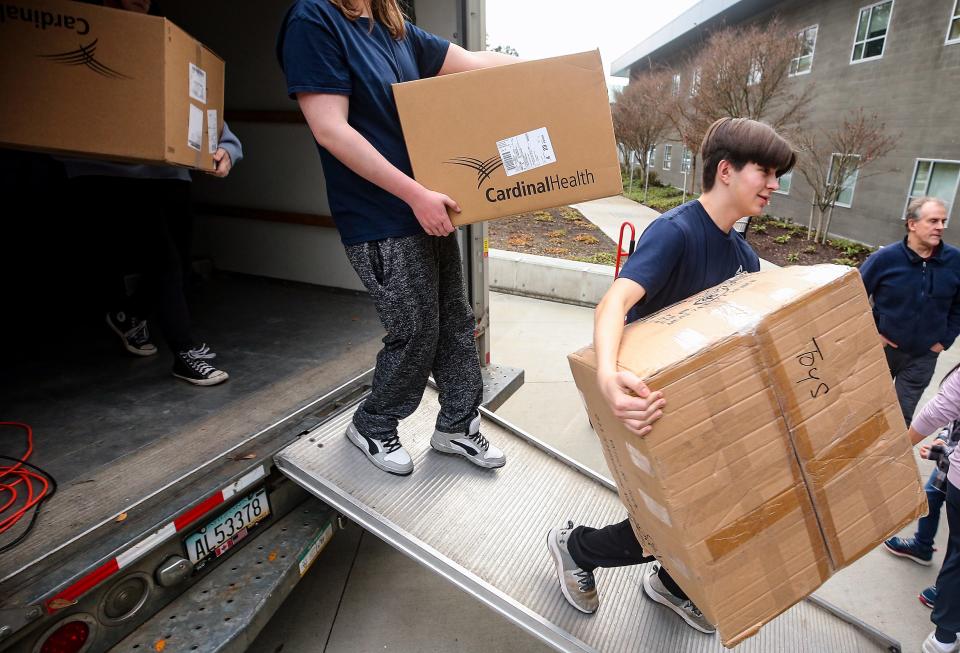 Zach Darner, 14, right, and the advisory board from his Kidzz Helping Kidzz nonprofit unload a truck of donated toys at St. Michael Medical Center in Silverdale on Thursday Dec. 21, 2023. Darner’s Kidzz Helping Kidzz has collected over 11,000 toys for this holiday season.