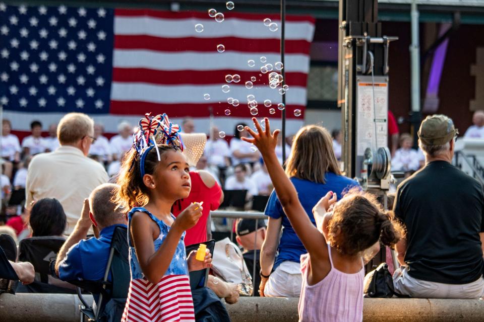 Children play with bubbles at Riehle Plaza on July 4, 2021, in Lafayette, Ind. People gathered around to celebrate the Fourth of July before the fireworks show.