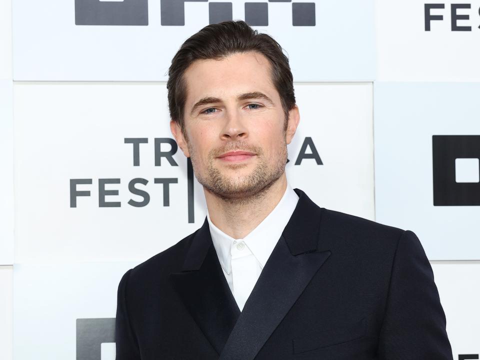 David Berry wearing a black blazer and a button-up white shirt with no tie.