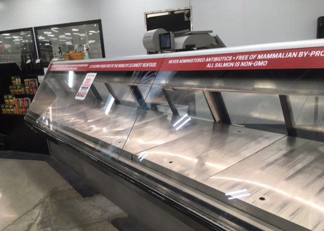 The seafood, meat, deli and bakery cases were empty Monday afternoon at Earth Fare's Saint Johns store, where a liquidation sale is underway as the store prepares to close this month.