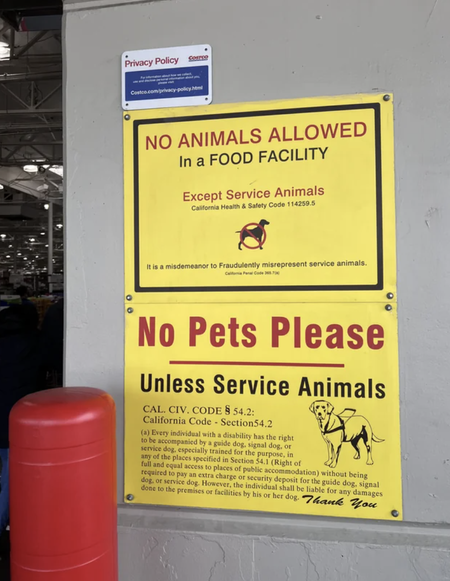 Sign reads "No Animals Allowed in a Food Facility" exception for service animals, citing California health codes