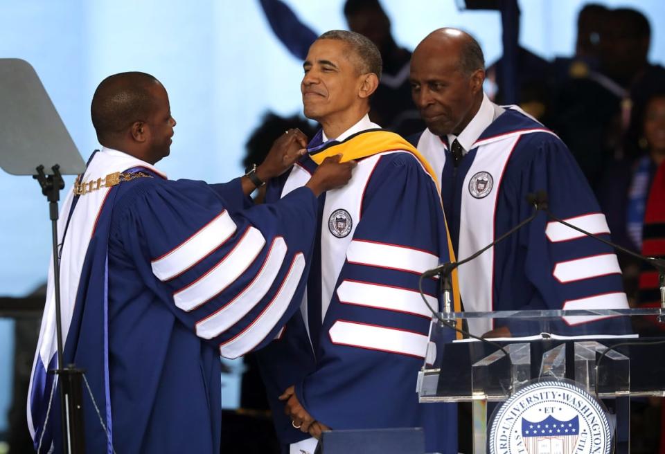 WASHINGTON, DC – MAY 07: Howard University President Dr. Wayne A. I. Frederick (L) helps to adjust the hood after U.S. <span class="caas-xray-inline-tooltip"><span class="caas-xray-inline caas-xray-entity caas-xray-pill rapid-nonanchor-lt" data-entity-id="Barack_Obama" data-ylk="cid:Barack_Obama;pos:2;elmt:wiki;sec:pill-inline-entity;elm:pill-inline-text;itc:1;cat:OfficeHolder;" tabindex="0" aria-haspopup="dialog"><a href="https://search.yahoo.com/search?p=Barack%20Obama" data-i13n="cid:Barack_Obama;pos:2;elmt:wiki;sec:pill-inline-entity;elm:pill-inline-text;itc:1;cat:OfficeHolder;" tabindex="-1" data-ylk="slk:President Barack Obama;cid:Barack_Obama;pos:2;elmt:wiki;sec:pill-inline-entity;elm:pill-inline-text;itc:1;cat:OfficeHolder;" class="link ">President Barack Obama</a></span></span> (C) was presented with a Doctor of Science honorary degree by member of Howard University Board of Trustees Vernon (R) Jordan during the 2016 commencement ceremony at Howard University May 7, 2016 in Washington, DC. President Obama is the sixth sitting U.S. president to deliver the commencement speech at Howard University. (Photo by Alex Wong/Getty Images)