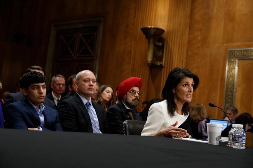 UN Ambassador-designate Gov. Nikki Haley, accompanied by her family, from left, Nalin Haley, husband Michael Haley and father Dr. Ajit Singh Randhawa, testifies on Capitol Hill in Washington, Wednesday, Jan. 18, 2017, at her confirmation hearing before the Senate Foreign Relations Committee.