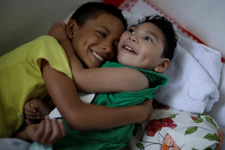 Daniel Vieira, who is two years old, and was born with microcephaly, is greeted by his brother at their house in Olinda, Brazil, August 7, 2018. REUTERS/Ueslei Marcelino/Files