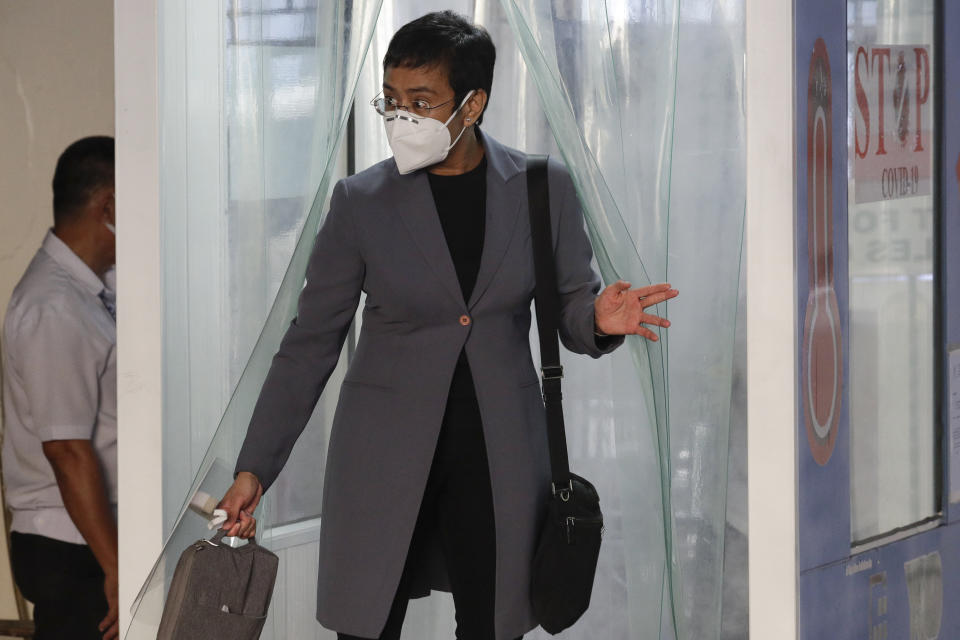 Rappler CEO and Executive Editor Maria Ressa, wearing a protective mask, exits a disinfection area before attending a court hearing at Manila Regional Trial Court, Philippines on Monday June 15, 2020. Ressa's verdict is expected to be announced Monday for a cyber libel case. (AP Photo/Aaron Favila)