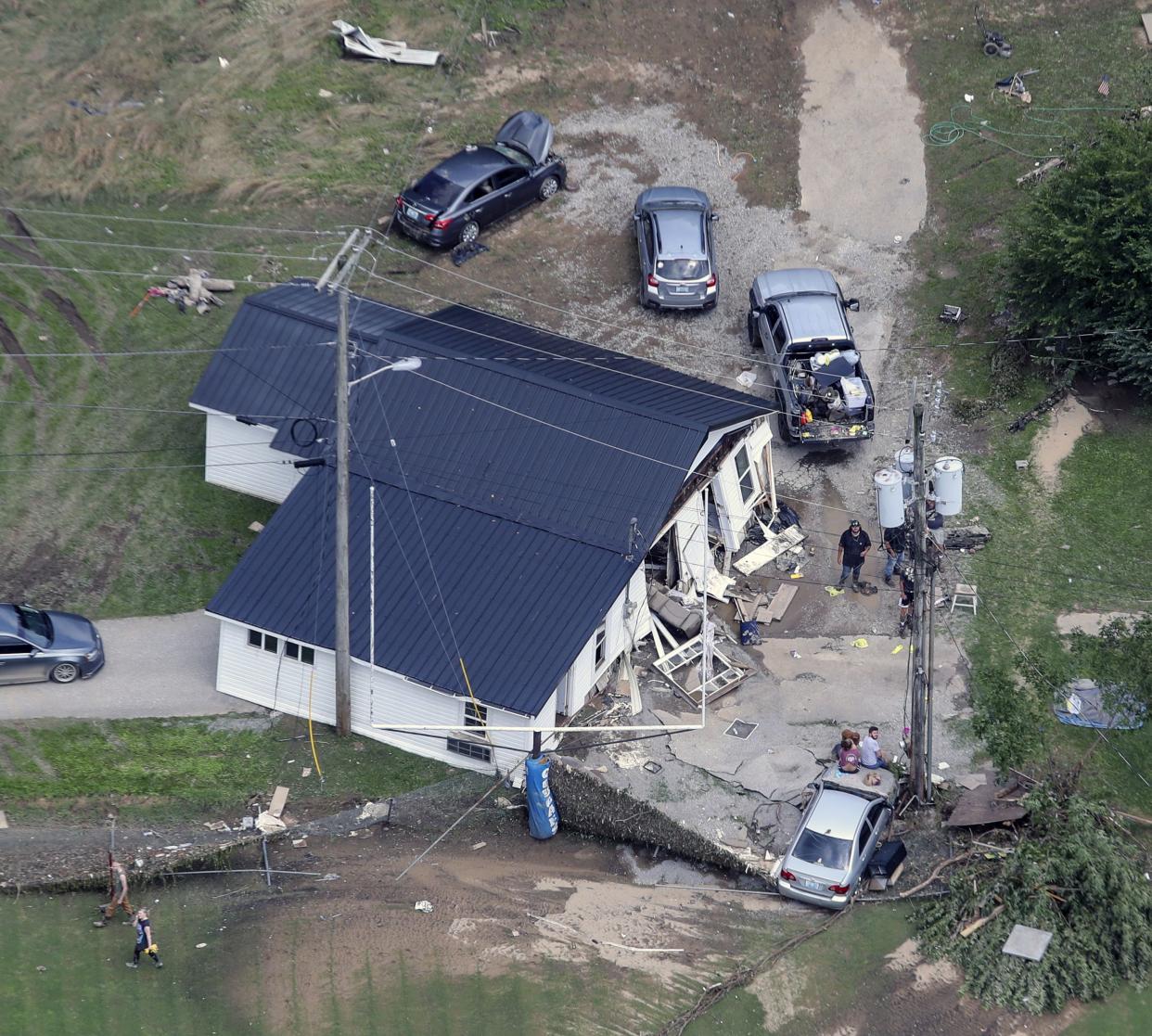 In this aerial image, a home in Eastern Kentucky is washed onto a road on Saturday, July 30, 2022, after historic rains during the week flooded many areas of Kentucky killing multiple people.