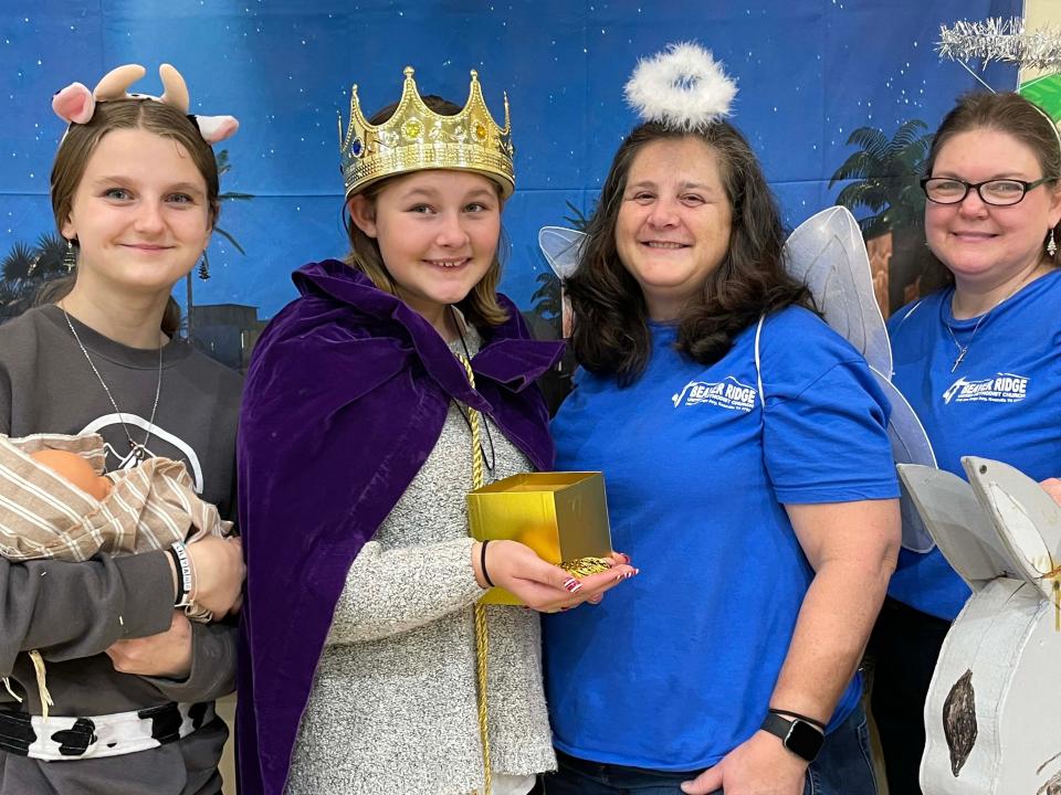 Ellyana Davidson, Abby Moazen, Suzanne Davidson, and Kerri Hunsaker Stannard make a Nativity scene at the annual Community Christmas Party Dec. 17, 2023, at Beaver Ridge United Methodist Church.