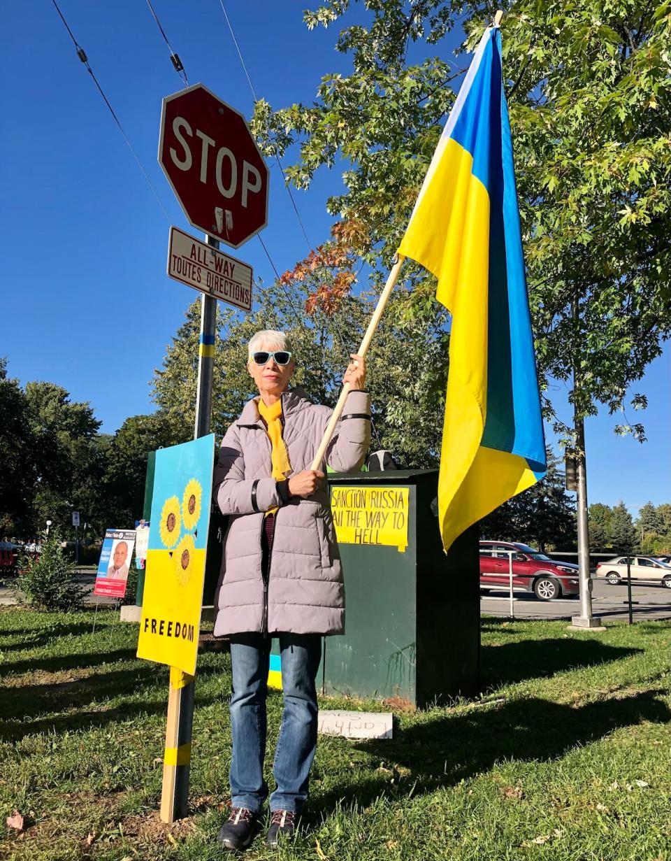Protester Karen Niven-Wigston stands outside the Russian consulate on Range Road in Ottawa on Friday, Sept. 23, 2022.