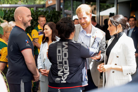 Britain’s Prince Harry and Meghan, the Duchess of Sussex meet Team UK competitors while attending a lunchtime Reception hosted by the Prime Minister with Invictus Games competitors, their family and friends in the city’s central parkland Sydney October 21, 2018.Paul Edwards /Pool via REUTERS