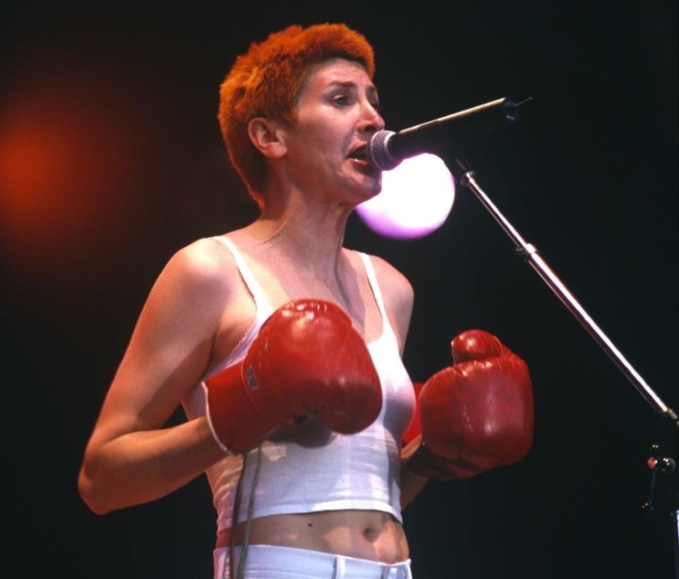 Alice Nutter performing on stage wearing boxing gloves