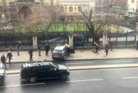 A picture obtained from the Twitter account of James West, shows a car stopped on the sidewalk in front of the Palace of Westminster which houses the Houses of Parliament in central London on March 22, 2017 during an incident