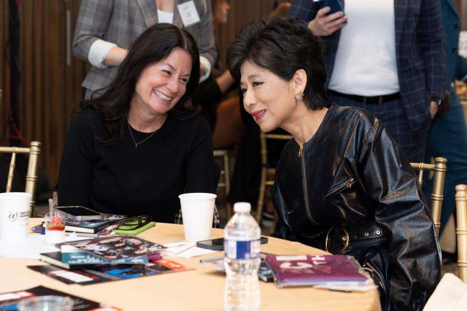 Chief marketing and public relations officer of Ally Financial Andrea Brimmer speaks with majority owner of the Washington Spirit and founder and CEO of Cognosante Michele Kang at the NWSL Score More for Title IX event at International Spy Museum.