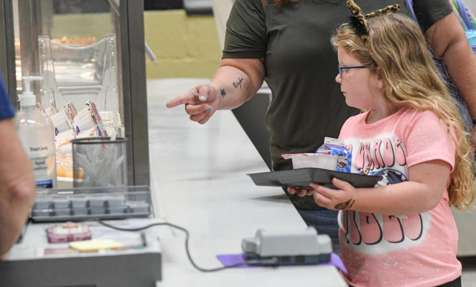 Kaia Todd gets her breakfast in the cafeteria during the first day of school at Pendleton Elementary of Anderson School District 4 Thursday, August 3, 2023.