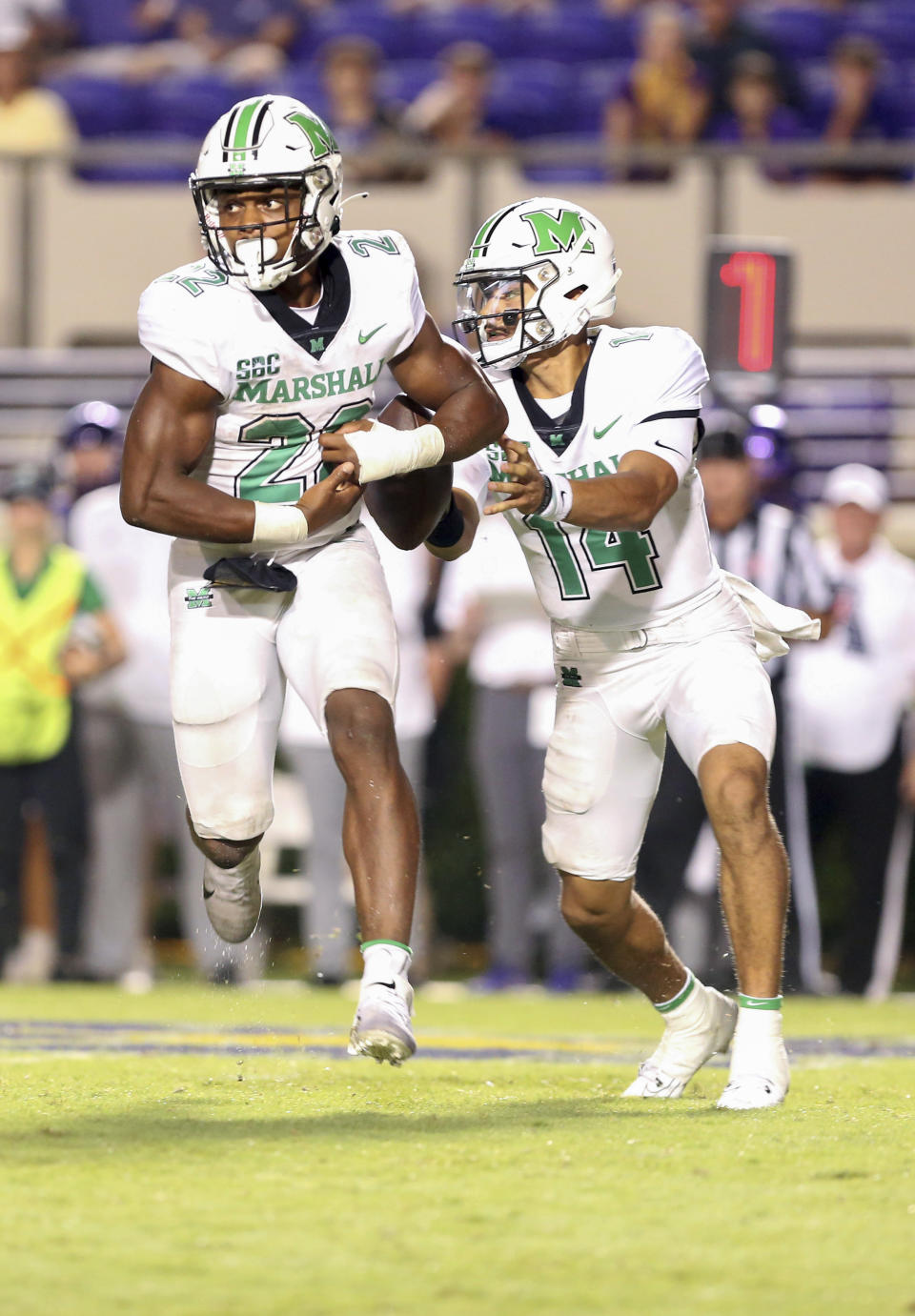 Marshall's Cam Fancher (14) hands off the ball to Rasheen Ali (22) during an NCAA college football game against East Carolina, Saturday, Sept. 9, 2023, in Greenville, N.C. (Scott Davis/The Daily Reflector via AP)