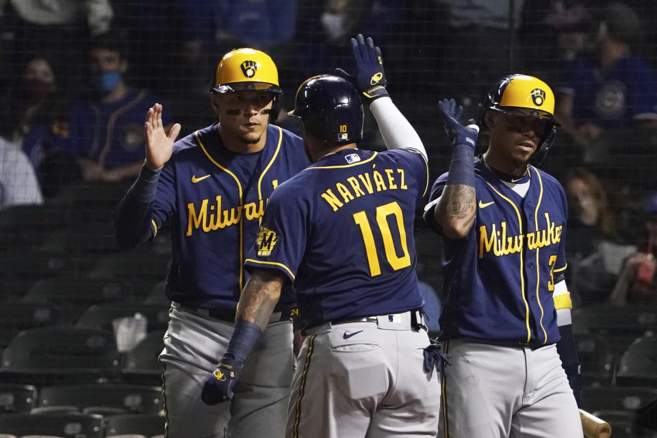 Milwaukee Brewers' Omar Narvaez (10) is greeted after hitting a three-run home run against the Chicago Cubs during the seventh inning of a baseball game, Monday, April 5, 2021, in Chicago. (AP Photo/David Banks)