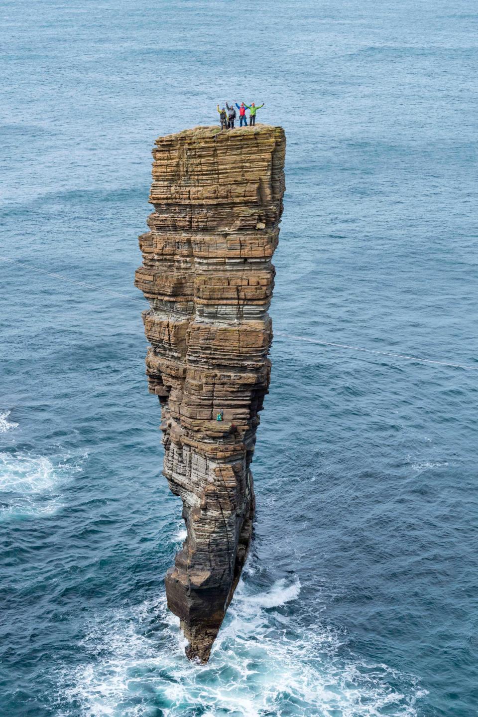 <p>Victory salute from the summit in Orkney, off the northern tip of Scotland. (Photo: Dave Cuthbertson/Caters News) </p>