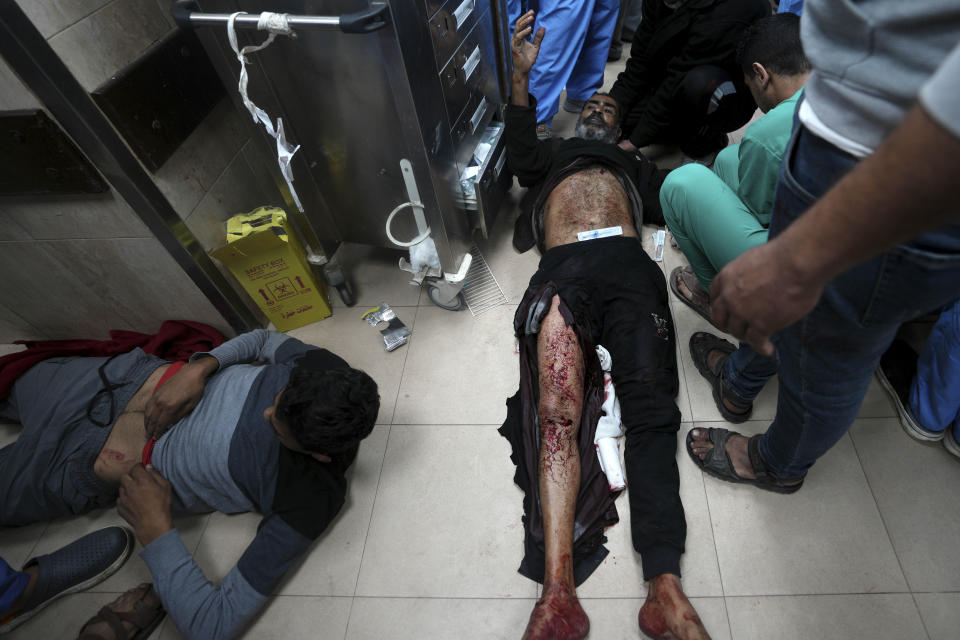 Palestinians wounded in the Israeli bombardment of the Gaza Strip are brought to the hospital in Deir al Balah, Gaza Strip, on Sunday, Dec. 24, 2023. (AP Photo/Adel Hana)