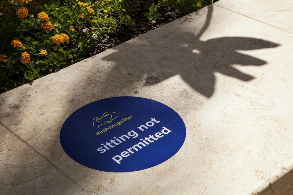 A sign notifies visitors that sitting is not permitted on a beach at the Whalers Village in Kaanapali, Maui County, Hawaii, U.S.