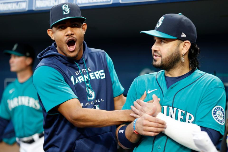 SEATTLE, WASHINGTON - SEPTEMBER 30: Julio Rodriguez #44 and Eugenio Suarez #28 of the Seattle Mariners joke before the game against the Oakland Athletics at T-Mobile Park on September 30, 2022 in Seattle, Washington. (Photo by Steph Chambers/Getty Images)