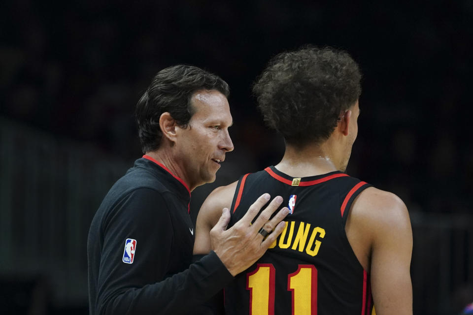 Newly hired Atlanta Hawks teach coach Quin Snyder talks with guard Trae Young (11) during the first half of an NBA basketball game against the Washington Wizards Tuesday, Feb. 28, 2023, in Atlanta. (AP Photo/John Bazemore)