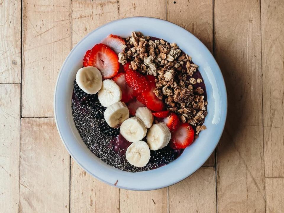 smoothie bowl with chia seeds, blackberries, bananas, strawberries, and granola