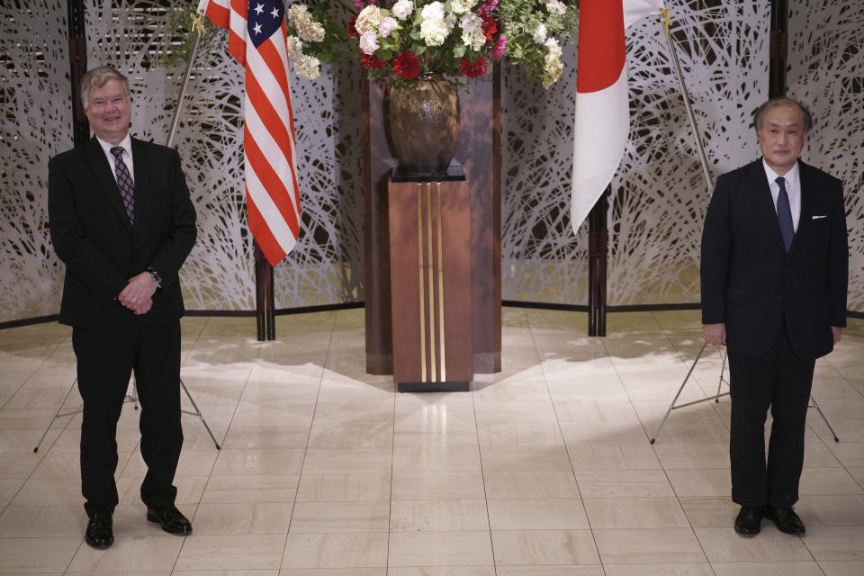 U.S. Special Representative for North Korea Stephen Biegun, left, and Japanese Vice Foreign Minister Takeo Akiba, right, pose for a photo session prior to their bilateral meeting at Iikura Guest House Thursday, July 9, 2020, in Tokyo. (AP Photo/Eugene Hoshiko, Pool)