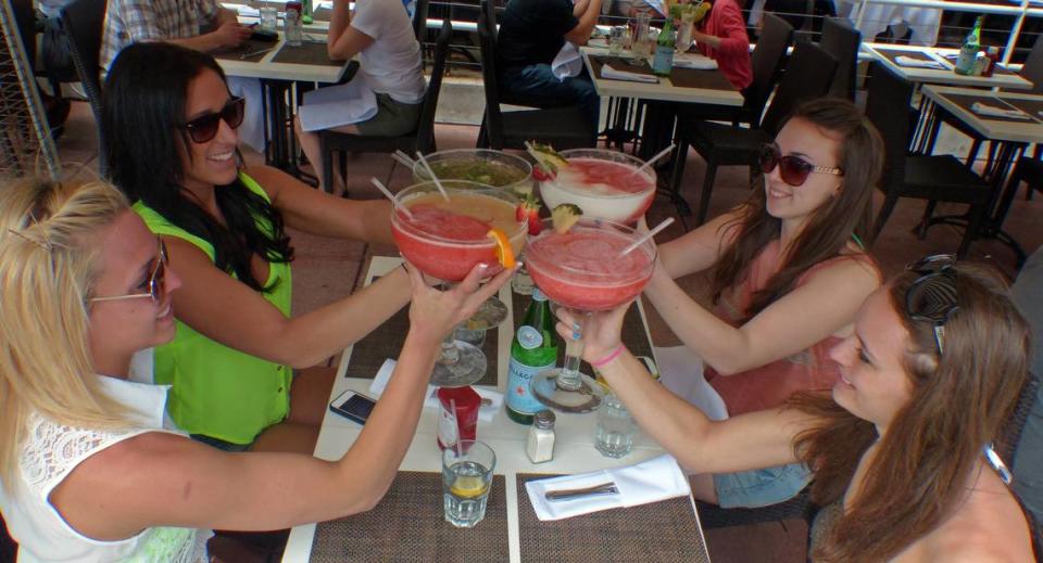 Megan Cockroft, (lower left then clockwise) Jordyn Fisher,. Kaitlyn Galati, and Alli Boettinger, all from Montclair State University just arrived from New Jersey for Spring Break. They are enjoying some large drinks along Ocean Drive on South Beach on March 11, 2013.