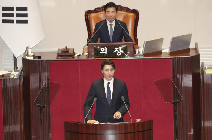 Canadian Prime Minister Justin Trudeau, bottom, delivers a speech as South Korea's National Assembly Speaker Kim Jin Pyo, top, listens at the National Assembly in Seoul, South Korea, Wednesday, May 17, 2023. (Korea Pool/Yonhap via AP)