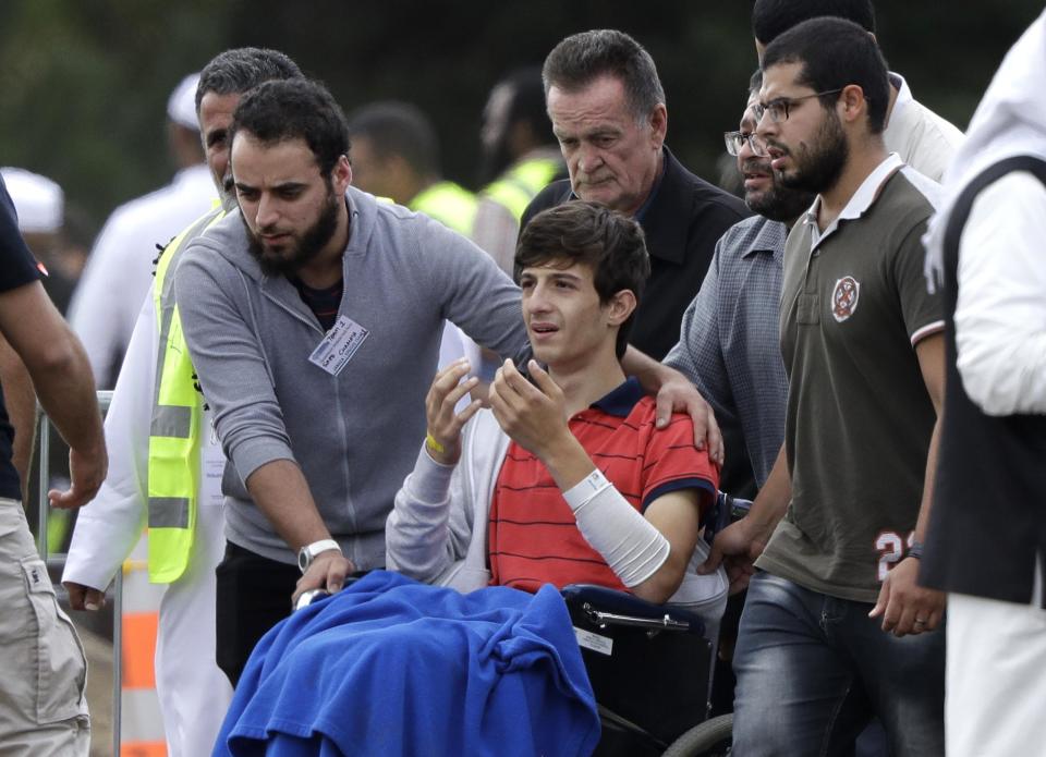 Zaed Mustafa, centre, brother of Hamza and son of Khalid Mustafa who were killed in the shootings (AP)